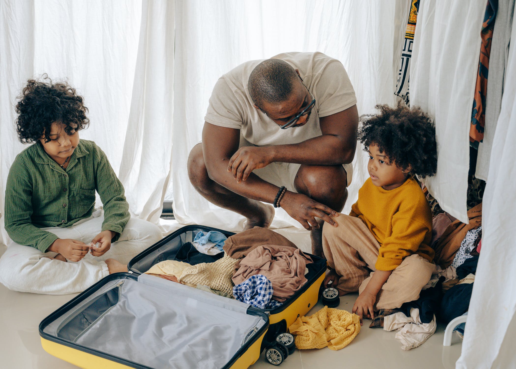 Black family packing suitcase