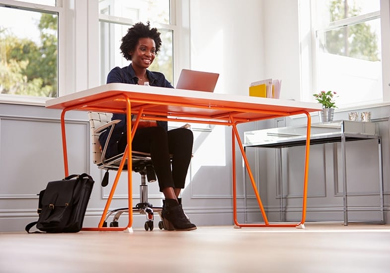 black woman sitting at her desk