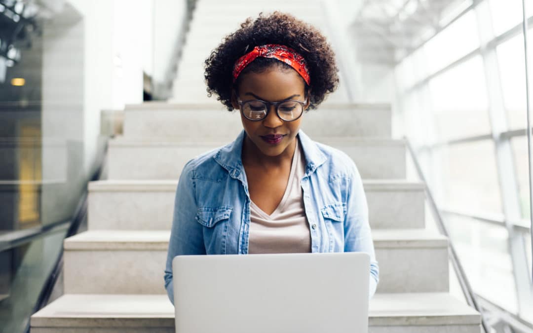 young black female college student researching on computer